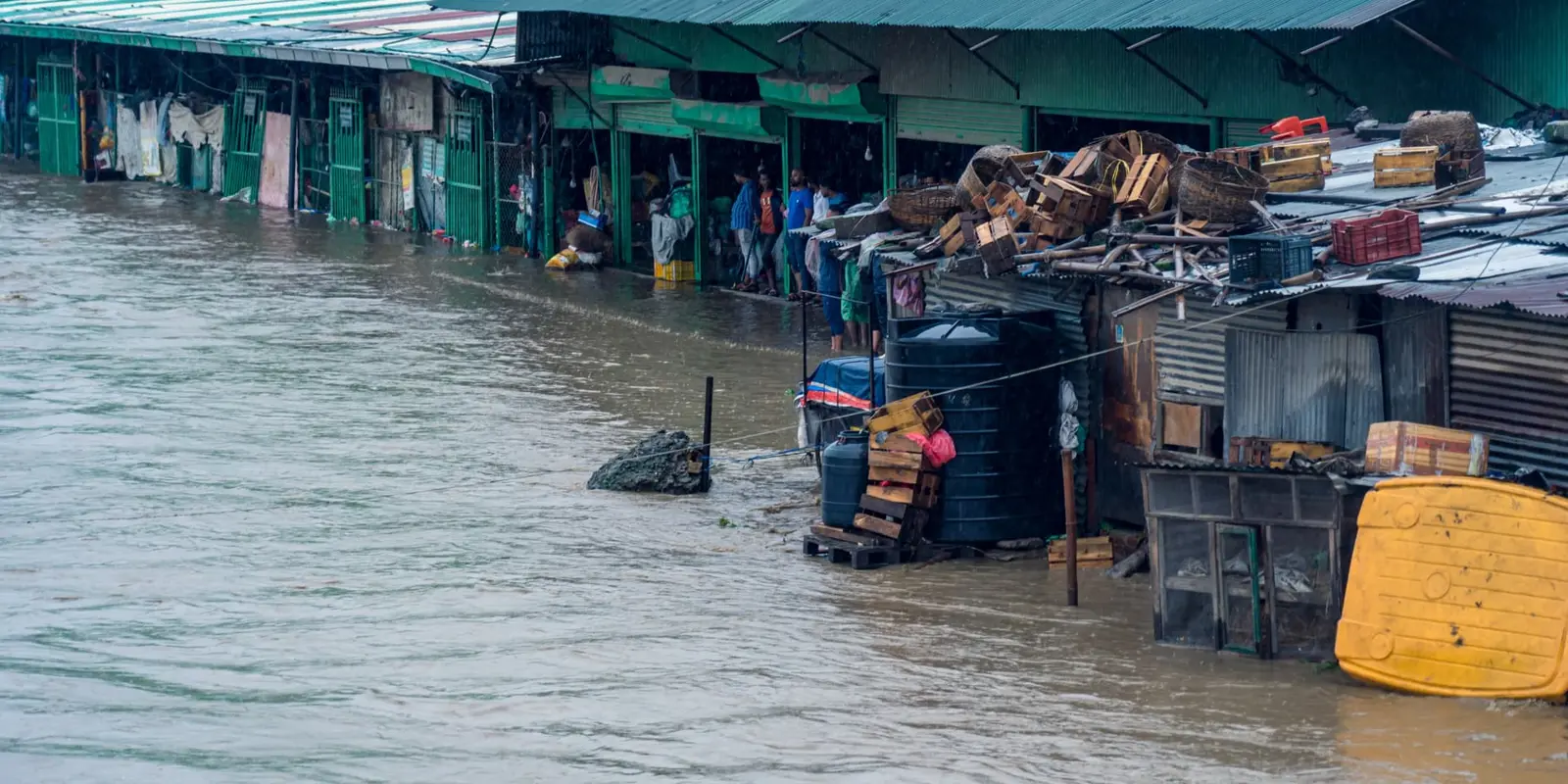 Flooded streets and shops in a South Asian market after a major flood