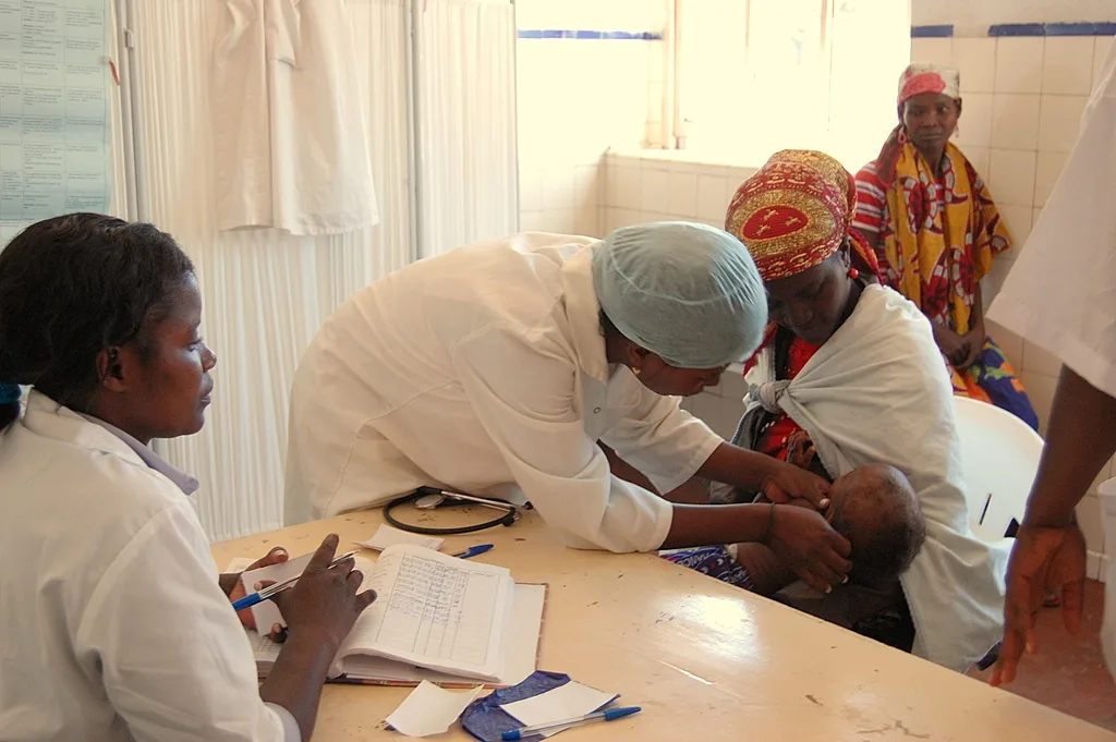 A health worker treating a patient at a community clinic